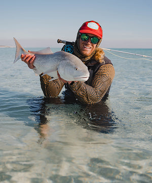 Saltwater fly angler with beautiful fish.